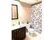 Clean bathroom with dark vanity, shower/tub combo, and white toilet at 316 Northpointe Ct, Danville, IN 46122