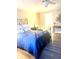 Bedroom with blue bedding, dark wood furniture, and hardwood floors at 316 Northpointe Ct, Danville, IN 46122