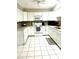 Modern kitchen with white cabinets and tile flooring at 316 Northpointe Ct, Danville, IN 46122