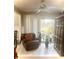 Bright living room with tile floors, leather chair, and view to backyard at 316 Northpointe Ct, Danville, IN 46122