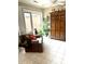 Sunroom with leather chair, plants, and wooden cabinet at 316 Northpointe Ct, Danville, IN 46122