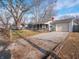 House with gravel driveway and chain link fence at 3931 N Faculty Dr, Indianapolis, IN 46254