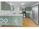 Modern kitchen featuring soft green cabinets and stainless steel appliances at 4151 Senour Rd, Indianapolis, IN 46239