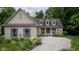 Tan house with blue shutters, landscaping, and a long driveway at 4655 Winterstill Rd, Zionsville, IN 46077