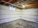 Unfinished basement with exposed beams and concrete floor at 5493 E 18Th St, Indianapolis, IN 46218