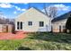 Brick patio, grassy yard, and wooden fence encompass this charming home's backyard at 5548 Carrollton Ave, Indianapolis, IN 46220