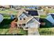 Two-story house with solar panels, a fenced backyard, and a nearby playground at 672 Rocky Meadow Dr, Greenwood, IN 46143
