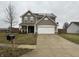 Two-story house with taupe vinyl siding, solar panels, and a spacious driveway at 672 Rocky Meadow Dr, Greenwood, IN 46143