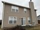 Rear view of the house with a sliding glass door and a small patio at 672 Rocky Meadow Dr, Greenwood, IN 46143
