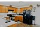 Modern kitchen with light wood cabinets, a black refrigerator, and stainless steel appliances at 672 Rocky Meadow Dr, Greenwood, IN 46143
