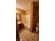 Bathroom with beige walls, tub, and wooden vanity at 717 N Elliott Ave, Martinsville, IN 46151