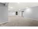 Spacious finished basement with built-in shelving and neutral carpeting at 7648 Three Arch Overlook, Noblesville, IN 46062