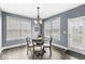 Bright breakfast nook with a table for four and access to the backyard at 7648 Three Arch Overlook, Noblesville, IN 46062