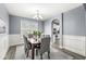 Bright dining room features a spacious table and chairs, hardwood floors, and an open view to the kitchen at 7648 Three Arch Overlook, Noblesville, IN 46062
