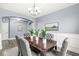 Formal dining room with a dark wood table, gray chairs, and wall art at 7648 Three Arch Overlook, Noblesville, IN 46062