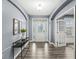 Bright and spacious entryway with hardwood floors and a modern console table at 7648 Three Arch Overlook, Noblesville, IN 46062