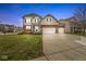 Two-story home with a three-car garage, neat landscaping, and a brick facade at 7648 Three Arch Overlook, Noblesville, IN 46062