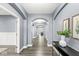 Elegant hallway with arched doorways, hardwood floors, and a neutral color palette at 7648 Three Arch Overlook, Noblesville, IN 46062