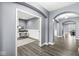 Neutral-toned hallway with hardwood floors and arched doorways leading to other rooms at 7648 Three Arch Overlook, Noblesville, IN 46062