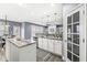 Open concept kitchen with granite countertops, white cabinets, and stainless steel appliances at 7648 Three Arch Overlook, Noblesville, IN 46062