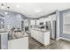 Modern kitchen with a large island, granite countertops, and stainless steel appliances at 7648 Three Arch Overlook, Noblesville, IN 46062