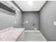 Laundry room with white cabinets and granite countertop at 7648 Three Arch Overlook, Noblesville, IN 46062