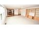 Bright living room with hardwood floors, built-in shelving, and view of kitchen at 8435 Smithfield Ln, Indianapolis, IN 46237