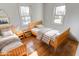 Two twin beds in a well-lit bedroom with hardwood floors at 9155 Melrose Ct, Indianapolis, IN 46239