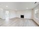 Living room featuring light gray flooring, a fireplace, and access to a sunroom at 1171 Thornwood Dr, Greenwood, IN 46143