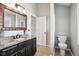 Bathroom with granite countertop, dark vanity, and updated fixtures at 1451 Clearwater Ct, Carmel, IN 46032