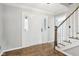 Bright entryway with hardwood floors, white door, and staircase at 1451 Clearwater Ct, Carmel, IN 46032