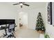 Home office with desk, chair, Christmas tree, and view into another room at 15449 Staffordshire Way, Fishers, IN 46037