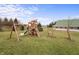Large backyard with playground and a barn in the distance at 16222 Browning Ct, Fishers, IN 46037