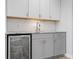 Basement bar with gray cabinets and granite countertop at 16222 Browning Ct, Fishers, IN 46037