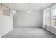Spacious dining room with gray walls, gray carpet, and a modern light fixture at 16222 Browning Ct, Fishers, IN 46037