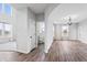 Open dining area with hardwood floors, view of a powder room, and access to the living room at 16222 Browning Ct, Fishers, IN 46037
