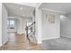 Open entryway with hardwood floors, gray carpeting, and a staircase at 16222 Browning Ct, Fishers, IN 46037