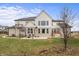 Two-story house with backyard, patio, hot tub, and fire pit at 16222 Browning Ct, Fishers, IN 46037