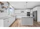 Modern kitchen with white cabinets, granite island, and copper accents at 16222 Browning Ct, Fishers, IN 46037