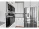 Modern kitchen features stainless steel appliances and white cabinetry at 16222 Browning Ct, Fishers, IN 46037