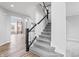 Modern staircase with black spindles and gray carpeting, leading to the second floor at 16222 Browning Ct, Fishers, IN 46037