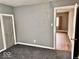 Grey bedroom with carpet flooring and access to another room at 2019 S Shipley St, Muncie, IN 47302