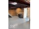 Open basement area with a gas fireplace and gray floor at 5967 S Lick Creek Rd, Morgantown, IN 46160