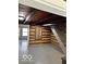 Unfinished basement with exposed log walls and gray floor at 5967 S Lick Creek Rd, Morgantown, IN 46160