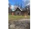 Rustic log cabin home with a metal roof and orange doors at 5967 S Lick Creek Rd, Morgantown, IN 46160