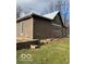 Side view of log cabin showcasing wood siding and stone accents at 5967 S Lick Creek Rd, Morgantown, IN 46160