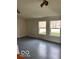 Bright living room with gray floor and two large windows at 5967 S Lick Creek Rd, Morgantown, IN 46160