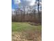 Open grassy yard with wooded backdrop at 5967 S Lick Creek Rd, Morgantown, IN 46160