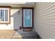 Inviting teal front door with a wreath and welcome mat at 6018 Thrushwood Dr, Indianapolis, IN 46250