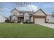 Two-story house with a large front yard and attached garage at 6023 Twyckenham Dr, Indianapolis, IN 46236